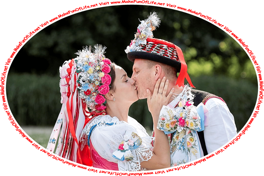 Picture of a man and a woman in festive costumes standing and kissing, and the words, ‘Visit www.MakeFunOfLife.net.’